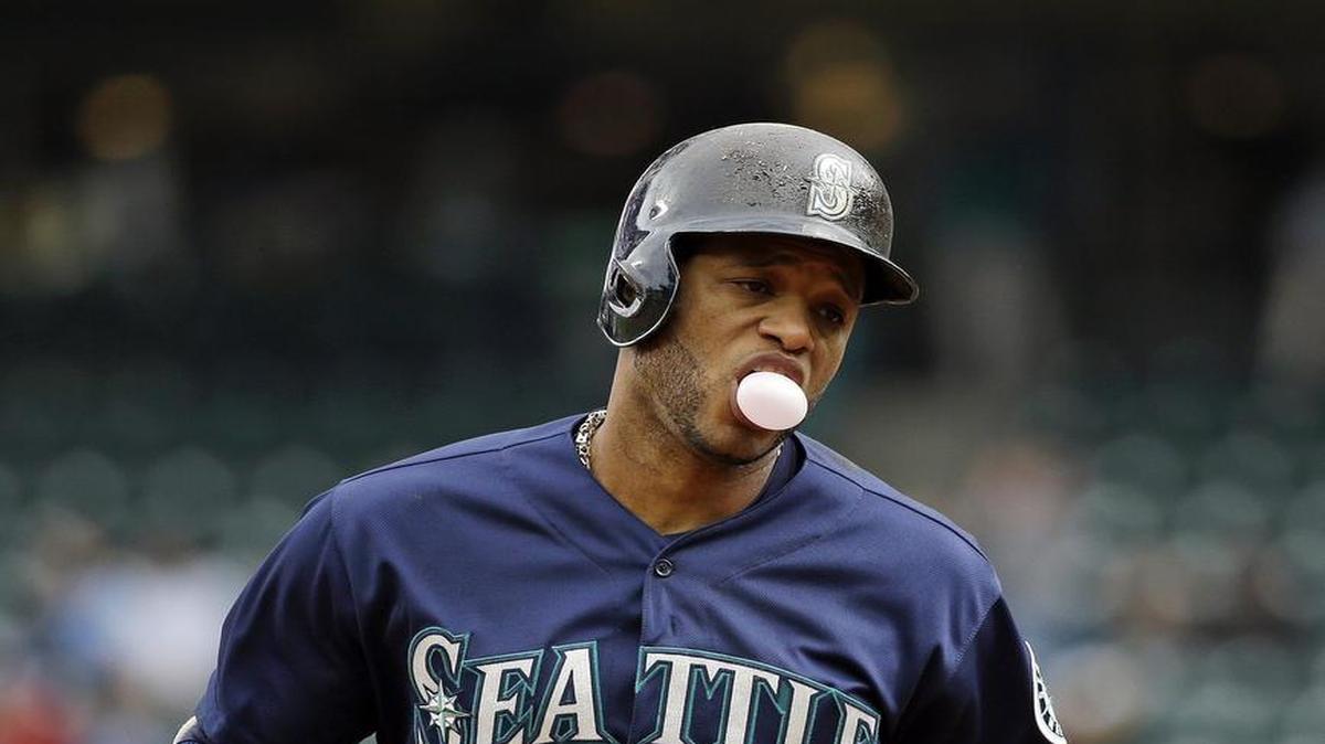 Seattle Mariners' Robinson Cano blows a bubble as he rounds the bases on his two-run home run against the Rangers during the first inning of a baseball game Monday, Sept. 5, 2016, in Seattle. (AP Photo/Elaine Thompson)