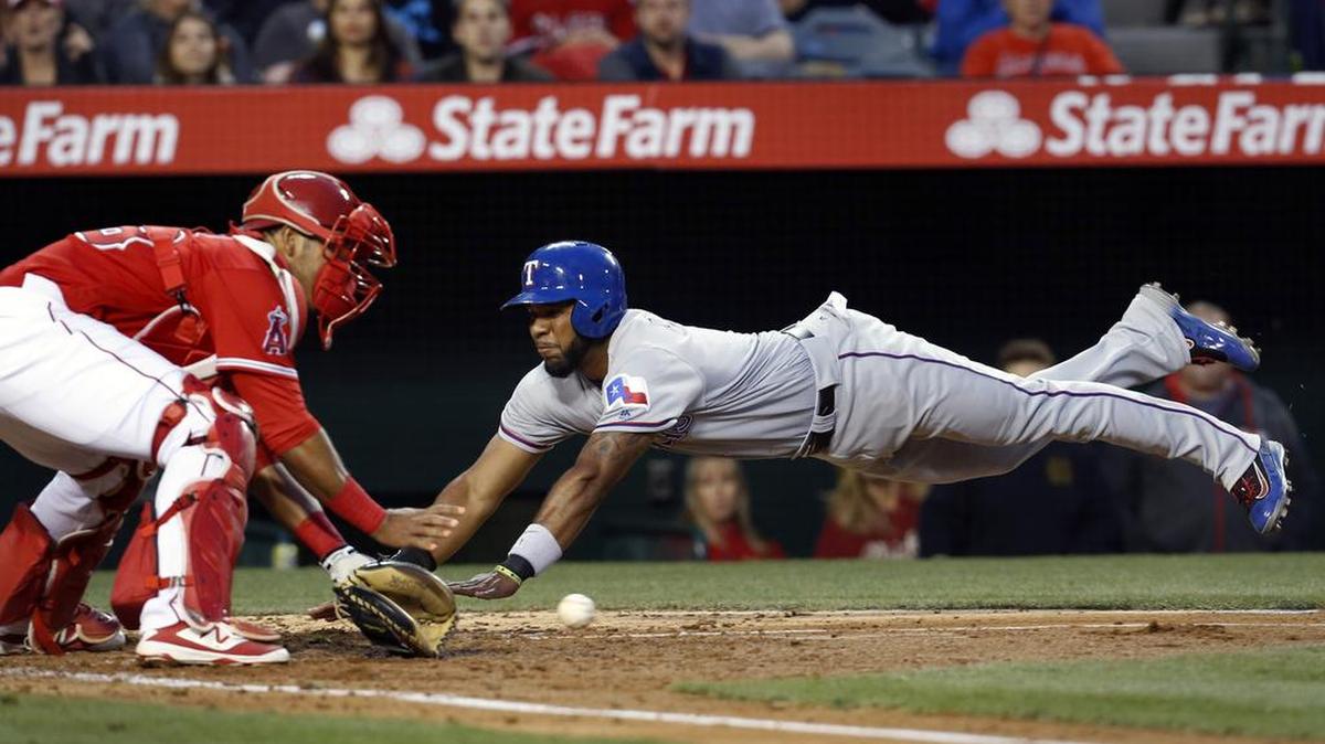 Elvis Andrus was out at home Saturday on his play and also had his left hand spiked by Carlos Perez.