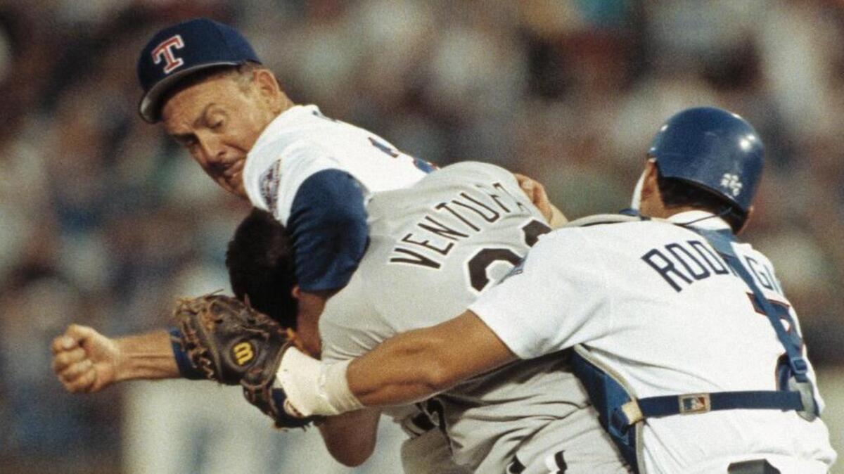 Texas Rangers pitcher Nolan Ryan, left, hits Robin Ventura of the Chicago White Sox after Ventura charged the mound in Arlington, Texas, on August 4, 1993.