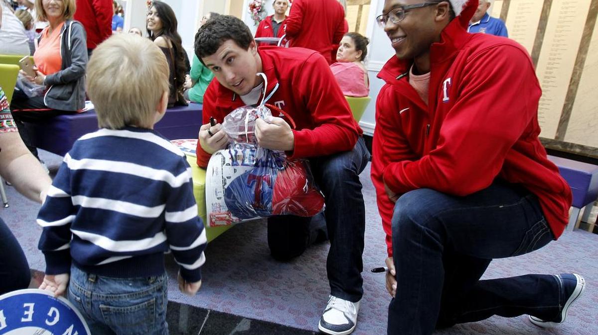 Rangers pitcher Derek Holland, left, and Dillon Tate, the team’s top pick in June’s draft, were among the club’s contingent Wednesday at Cook Children’s Medical Center.