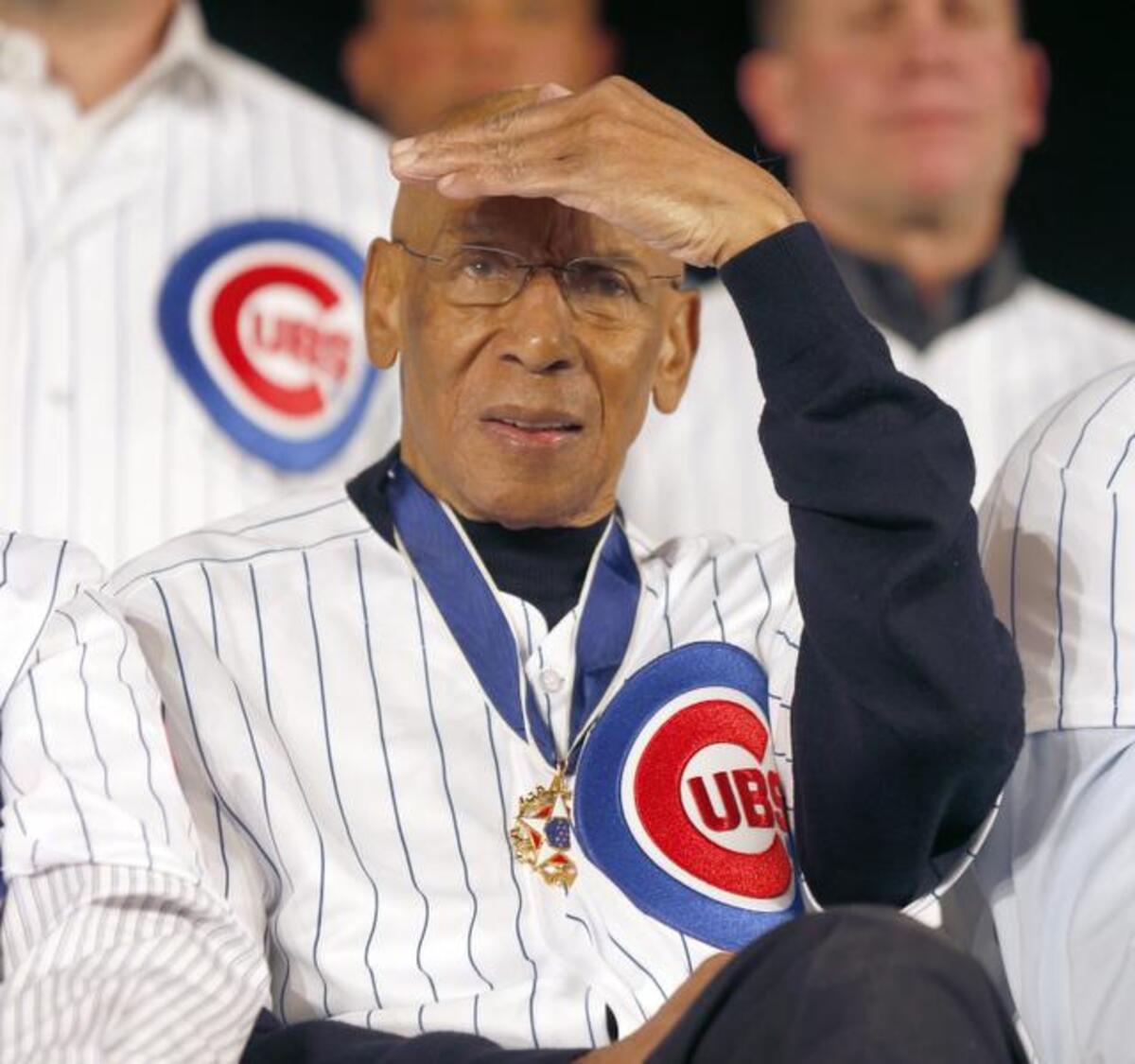 Chicago Cubs’ Hall of Fame infielder, “Mr. Cub” Ernie Banks shields his eyes from a spotlight during the Cubs’ annual winter baseball convention in Chicago in this Jan. 17, 2014 file photo. Ernie Banks, the two-time MVP who never lost his boundless enthusiasm for baseball despite years of playing on losing Chicago Cubs teams, died Friday night. He was 83. The Cubs announced Banks’ death, but did not provide a cause.
