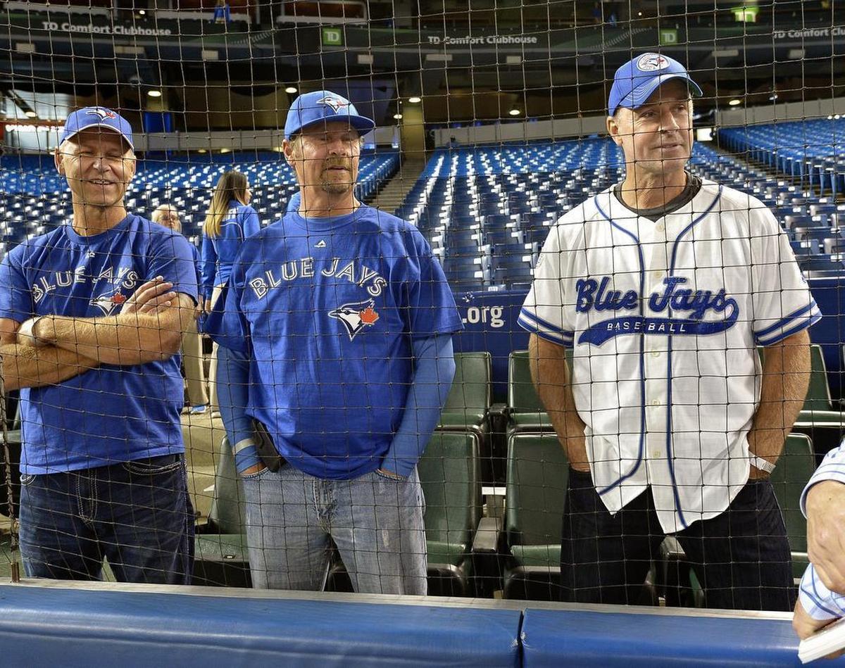 Former Dallas Stars center Joe Nieuwendyk, right, watches as the Toronto Blue Jays take batting practice before the ALDS Game 3 at Rogers Centre Sunday.