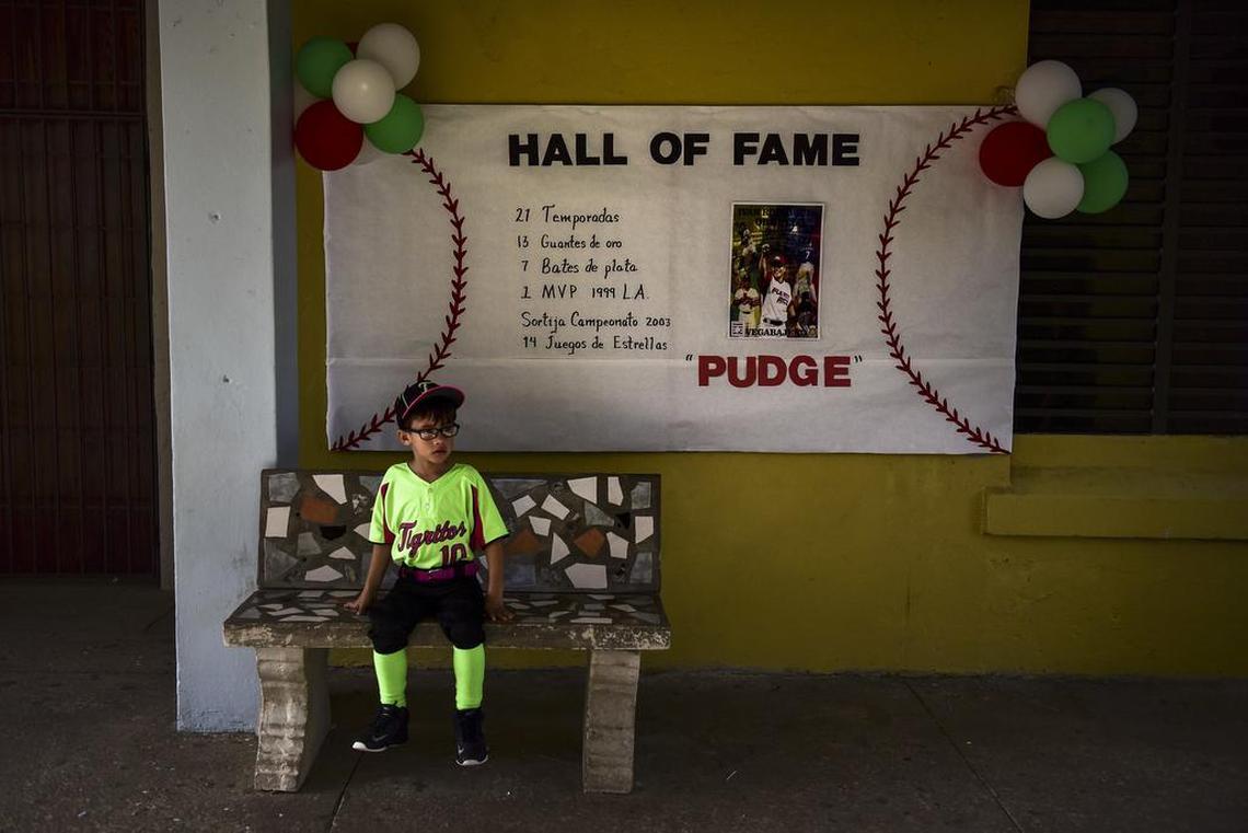 A student waits for Pudge Rodriguez, who visited his hometown school, José Gualberto Padilla Elementary, in Vega Baja, Puerto Rico, Friday, Jan. 27. Rodriguez is the fourth native Puerto Rican inducted into the Baseball Hall of Fame and is the youngest inductee at 45.