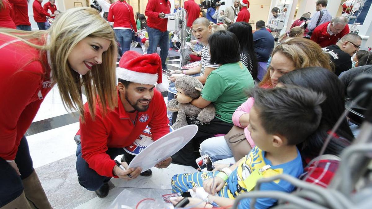Rangers catcher Robinson Chirinos and his wife Heidi visit with kids at Cook Children’s Medical Center in Fort Worth.