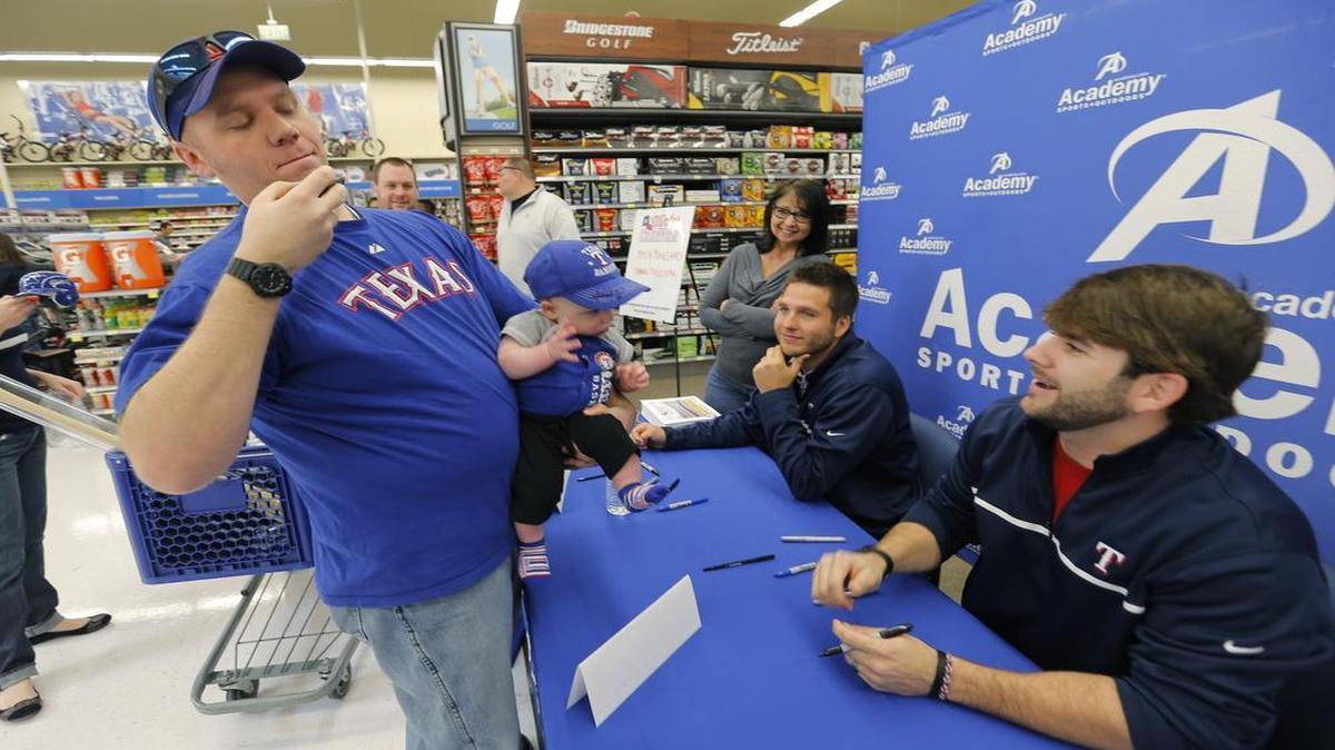 A Rangers’ fan takes a photo of Mitch Moreland and Shawn Tolleson at a Rangers’ winter caravan stop in January 2014.