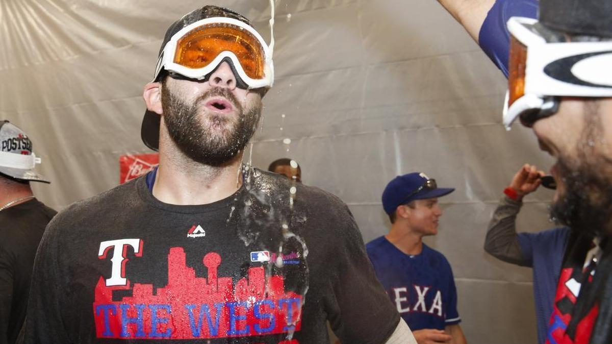 
Mitch Moreland celebrates in the clubhouse following the Rangers’ 9-2 win A.L. West-clinching win against the Angels Sunday afternoon. The championship shirt he is wearing with the Dallas skyline will not be restocked, the Rangers said.
