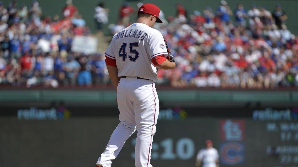 
Rangers starting pitcher Derek Holland reacts to a two-run home run by Toronto Blue Jays third baseman Josh Donaldson in the first inning Monday. Toronto evened the best of five series with an 8-4 win at Globe Life Park.
