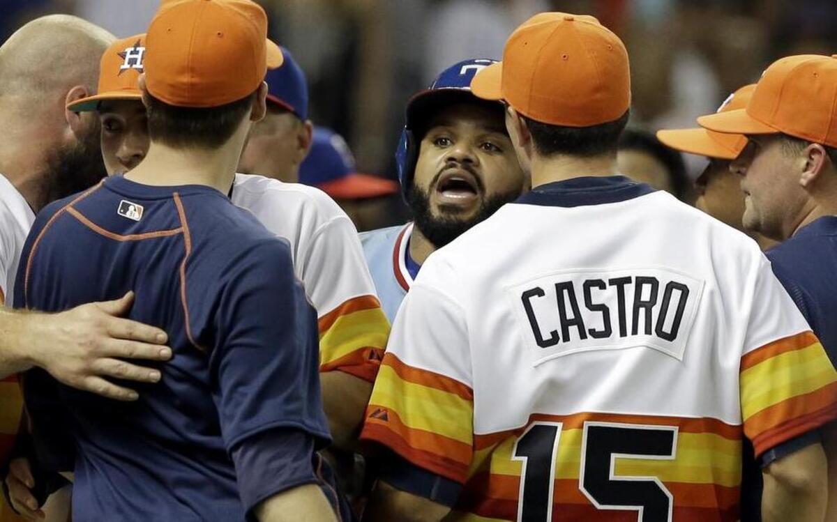 
Rangers’ Prince Fielder, center, confronts Astro’ Jed Lowry, in navy blue, after both benches cleared in the ninth inning.
