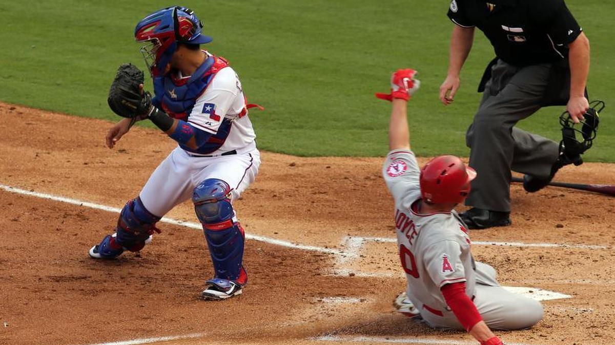 
Texas Rangers catcher Robinson Chirinos (61) gets the throw too late as Los Angeles Angels Matt Joyce (20) scores in the second inning at Globe Life Park in Arlington Sunday, July 5, 2015. 
