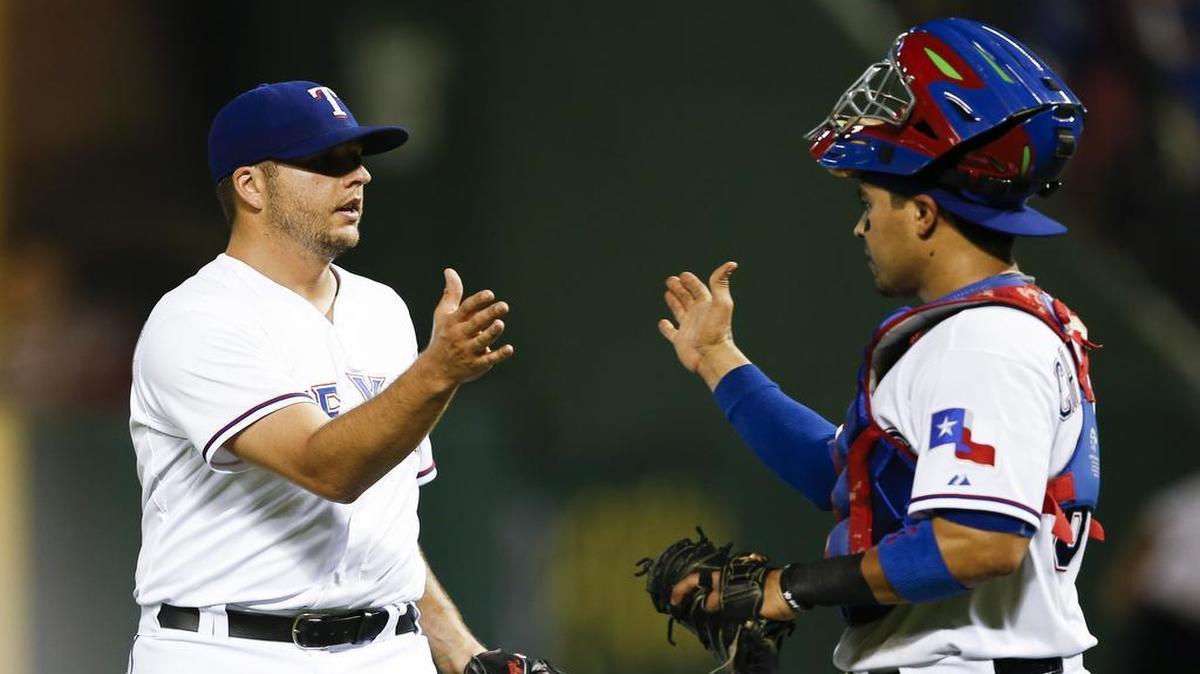 
Rangers relief pitcher Shawn Tolleson, left, and catcher Robinson Chirinos celebrate Thursday’s win. Chirinos injured his left shoulder during a swing in the eighth inning during the game and was put on the 15-day disabled list Saturday.
