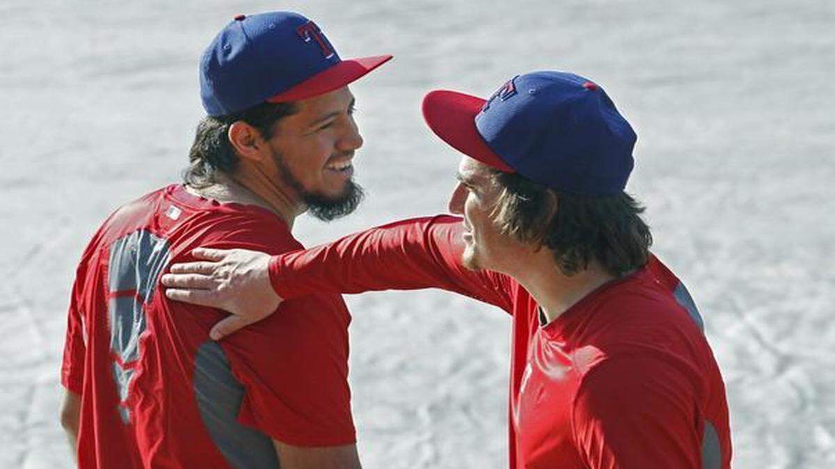 
Yovani Gallardo, left, and Luke Jackson are in the minority as long-haired Rangers pitchers.


