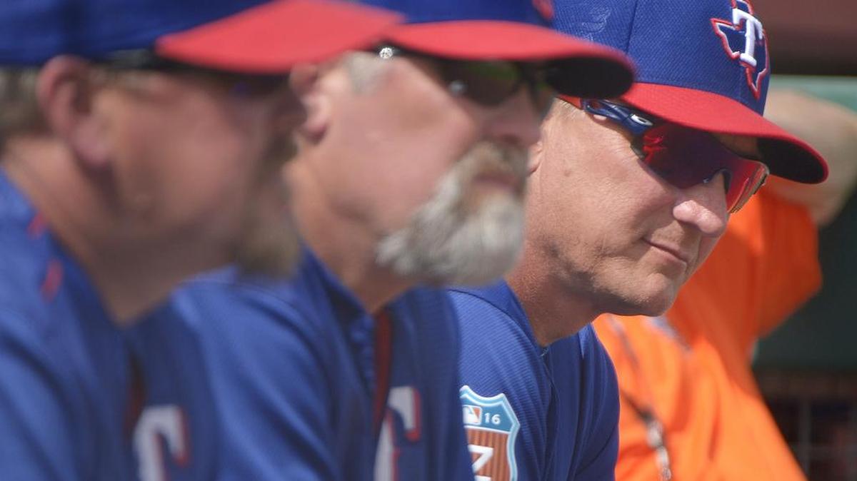 From left: Texas Rangers bullpen coach Brad Holman (40), pitching coach Doug Brocail (46) and manager Jeff Banister (28) watch starting pitcher Cole Hamels (35) during a spring training game.
