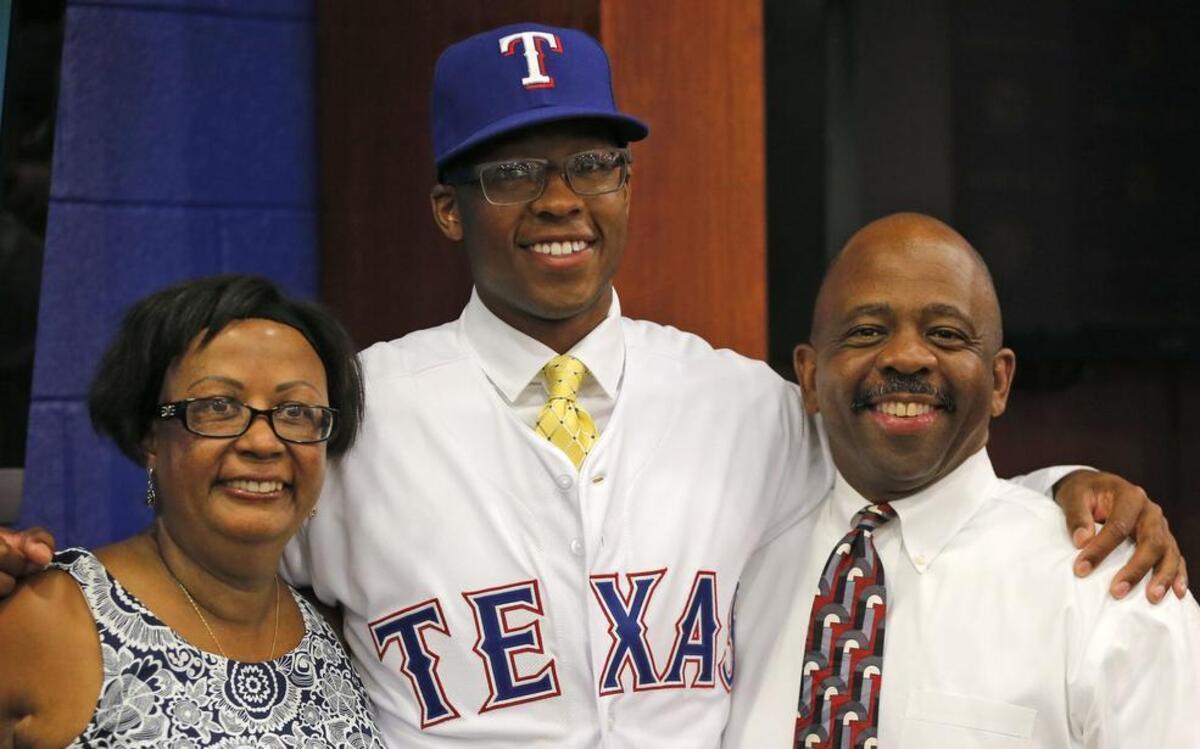 
Rangers top draft pick UC Santa Barbara pitcher Dillon Tate with his mother Lenora and father Anthony during a press conference at Globe Life Park Friday night.
