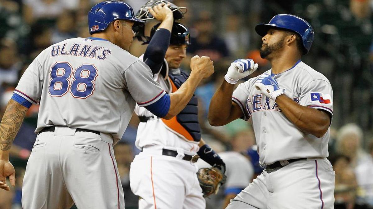 
Carlos Peguero, right, celebrates with Kyle Blanks after staking the Rangers to a 4-0 lead with a two-run home run in the first.

