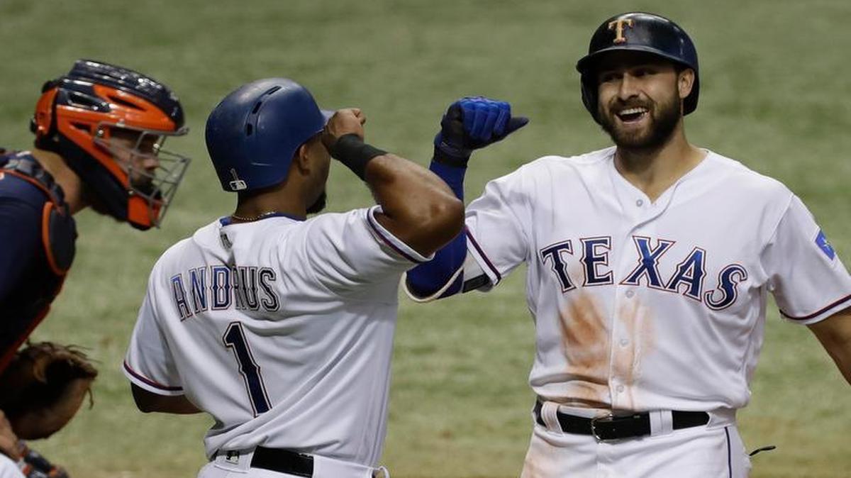Texas Rangers' Joey Gallo, right, celebrates his two-run home run off Houston Astros starting pitcher Mike Fiers with Elvis Andrus during the third inning of a baseball game Tuesday, Aug. 29, 2017, in St. Petersburg, Fla. The Astros moved their three-game home series against the Rangers to St. Petersburg because of unsafe conditions from Hurricane Harvey.