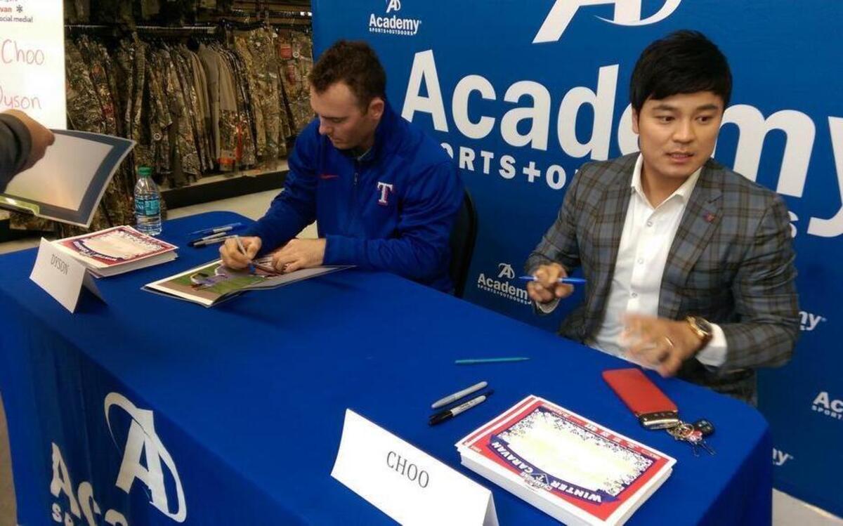Rangers players Shin-Soo Choo, right, and Sam Dyson, signed autographs at a winter caravan appearance in North Fort Worth on Sunday afternoon.
