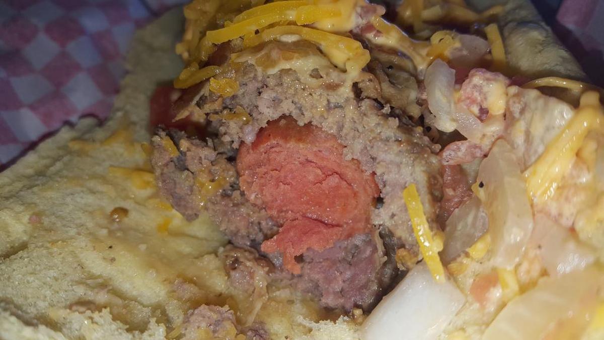 The Triple Play is a hot dog wrapped in hamburger, which is then wrapped in bacon. It’s a new, 890-calorie concession item at Surprise Stadium in Arizona, spring training home of the Rangers and Royals.