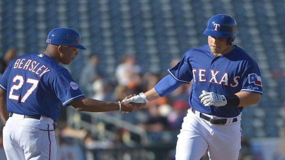 
Rangers third base coach Tony Beasley, left, has been singing in church choirs all his life, and has sung the National Anthem as a player in the minor leagues and again as a coach. 



