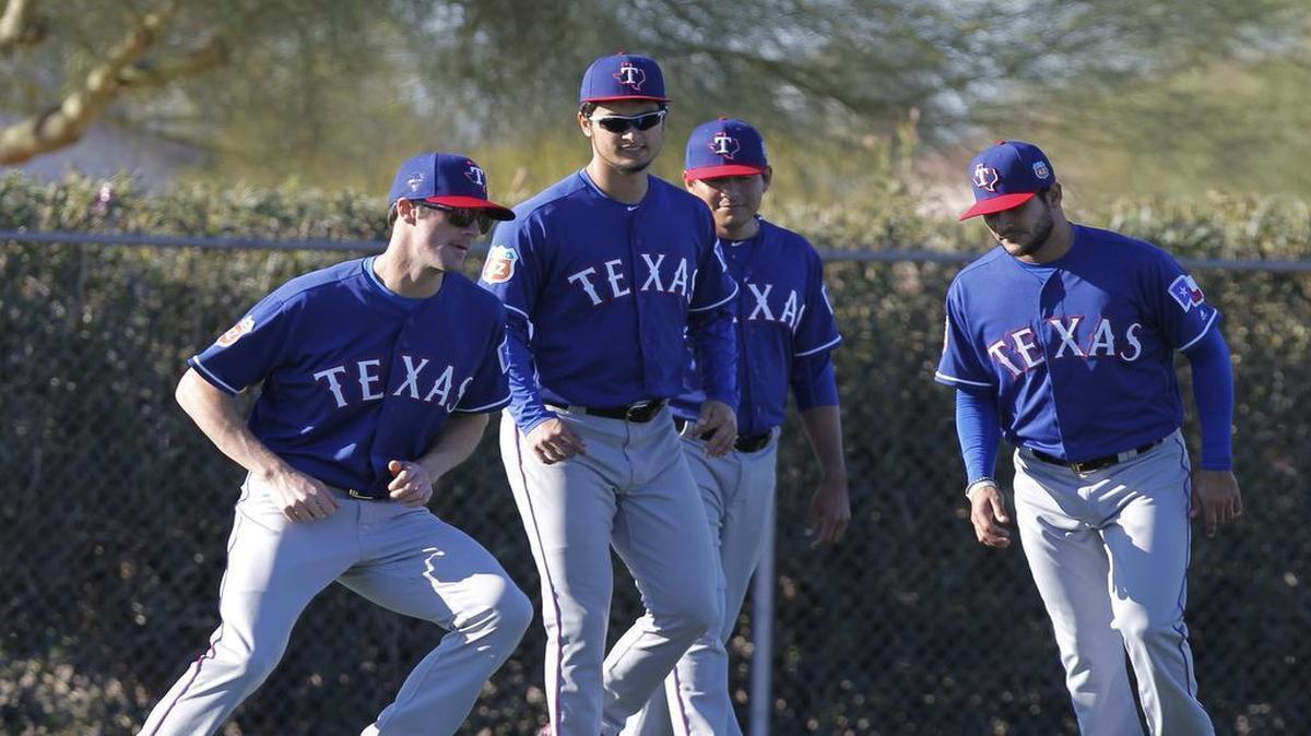 Cole Hamels, left, Yu Darvish, Cesar Ramos and Martin Perez work on agility exercises during spring training. Hamels and Darvish are scheduled to make starts Sunday, Hamels for the Rangers and Darvish with Double A Frisco.