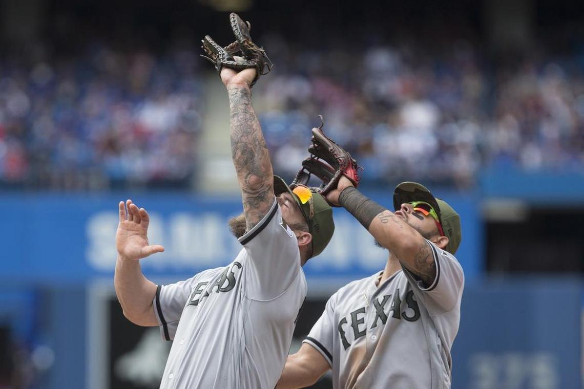 First baseman Mike Napoli, left, makes a catch in front of second baseman Rougned Odor, right, in the seventh on a pop up in front of first base on Sunday at Rogers Centre. Rangers fielders ran into each other several times during the series.