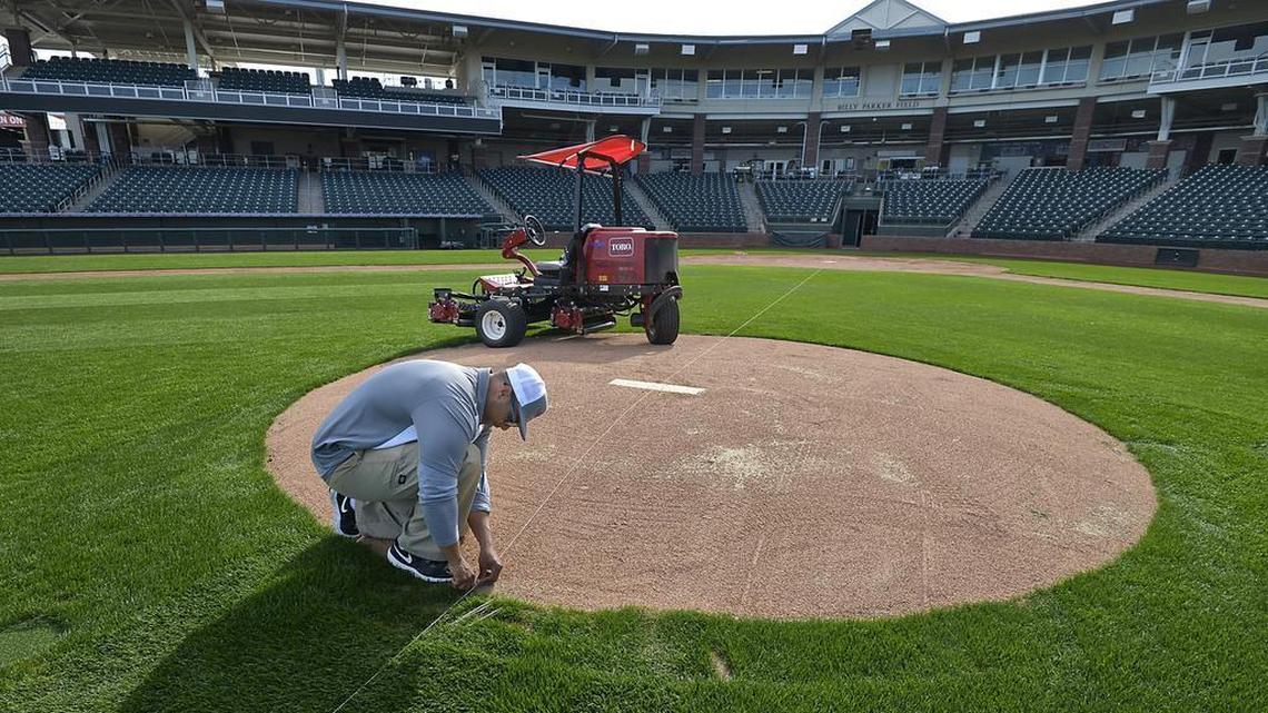 Kevin Anderson puts down the guide lines as he mows the grass at Surprise Stadium in preparation for the opening of the Rangers spring training in Surprise, Ariz., in February 2017.