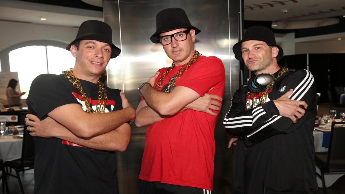 Rangers general manager Jon Daniels, left, former assistant GM Thad Levine and professional scouting director Josh Boyd dressed as RUN DMC for the Do It for Durrett 80’s Night charity event at Globe Life Park in 2015.