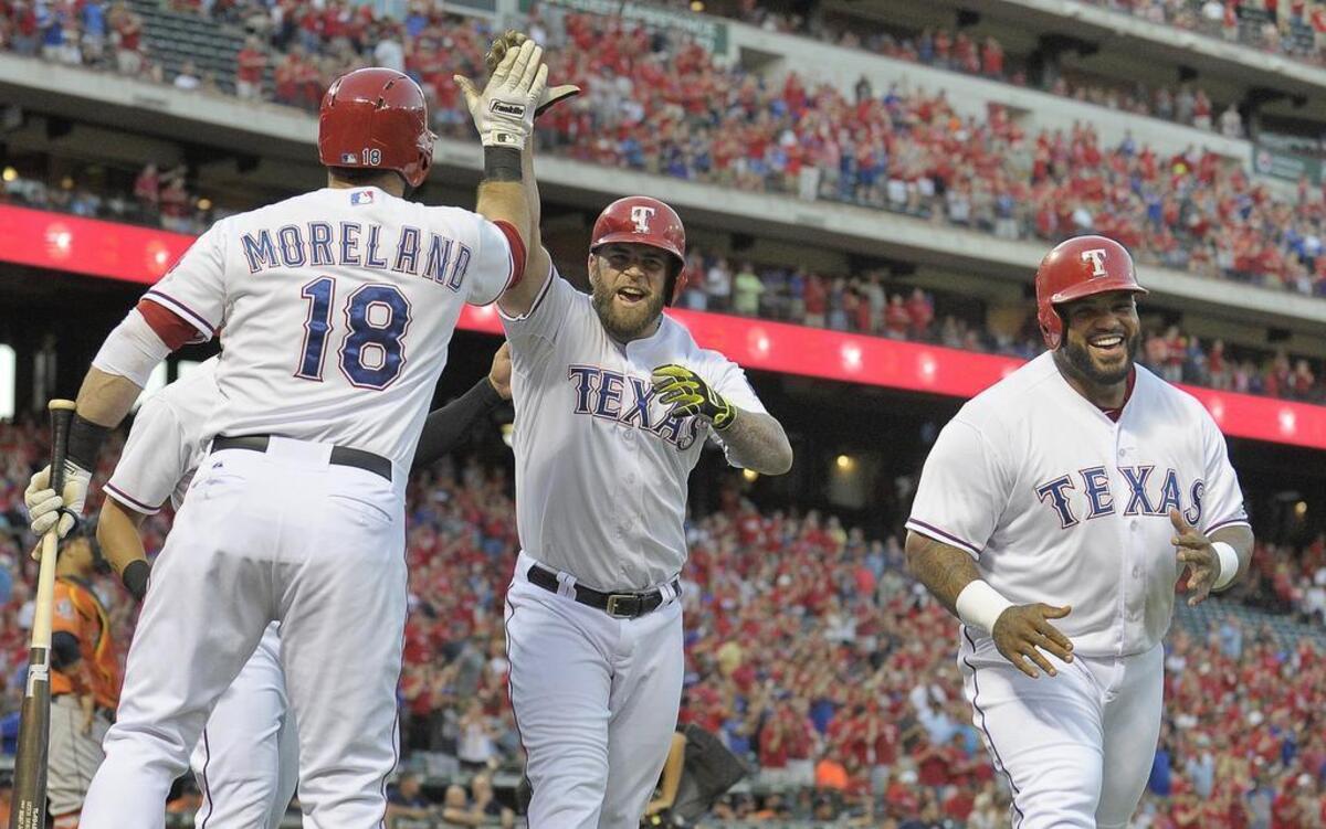
Rangers first baseman Mitch Moreland celebrates with left fielder Mike Napoli, middle, and designated hitter Prince Fielder, right, after Napoli's first inning three-run homer against the Astros. Texas hit five homers and beat Houston 14-3. 
