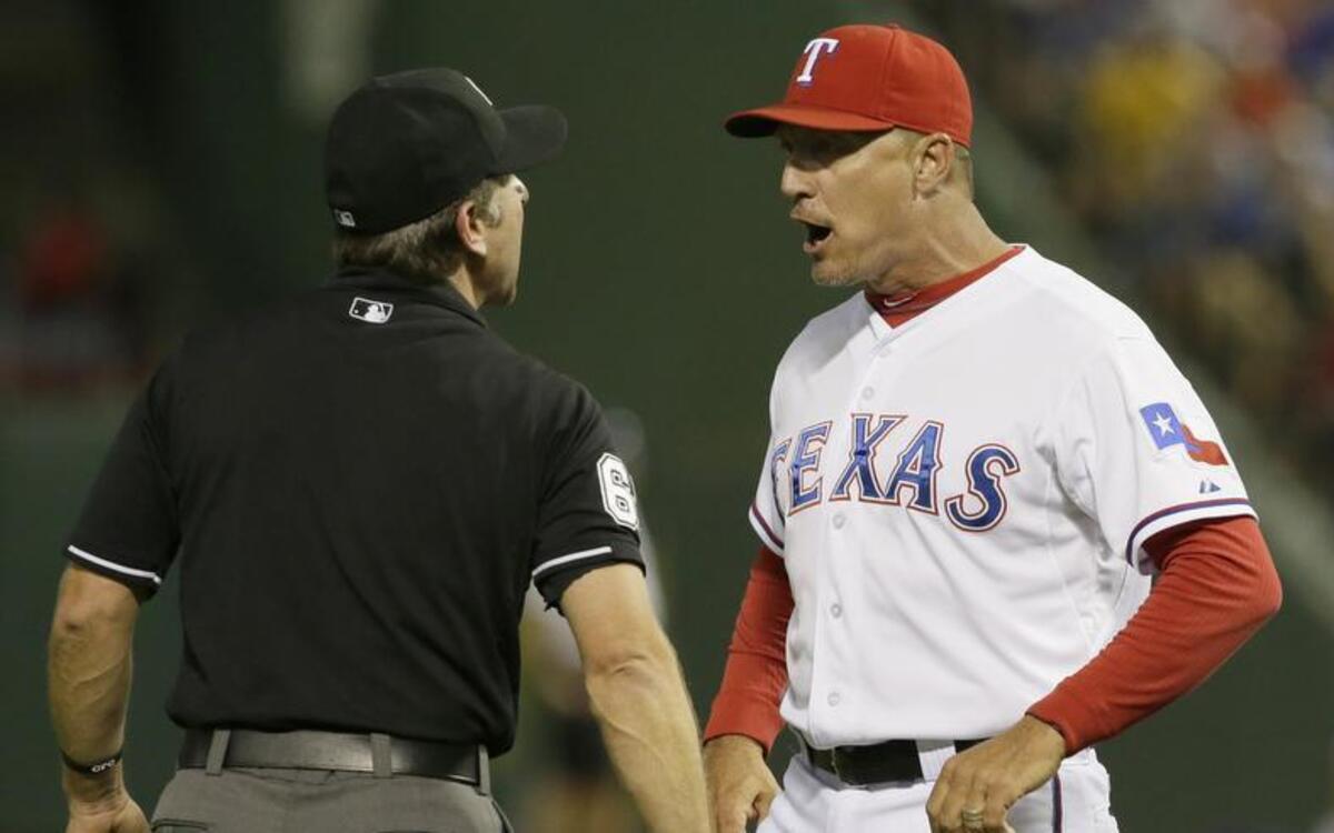 
Rangers manager Jeff Banister, right, was ejected after arguing with umpire Anthony Johnson during the second inning Friday night. Texas lost to Seattle 3-1.
