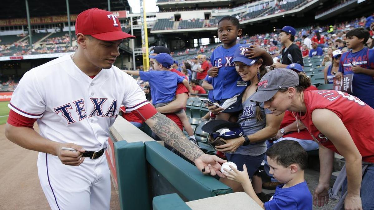 Rangers reliever Keone Kela signs autographs for fans in May. He is close to returning from surgery on his right elbow in April. He hopes to be back before the All-Star Game on July 12.