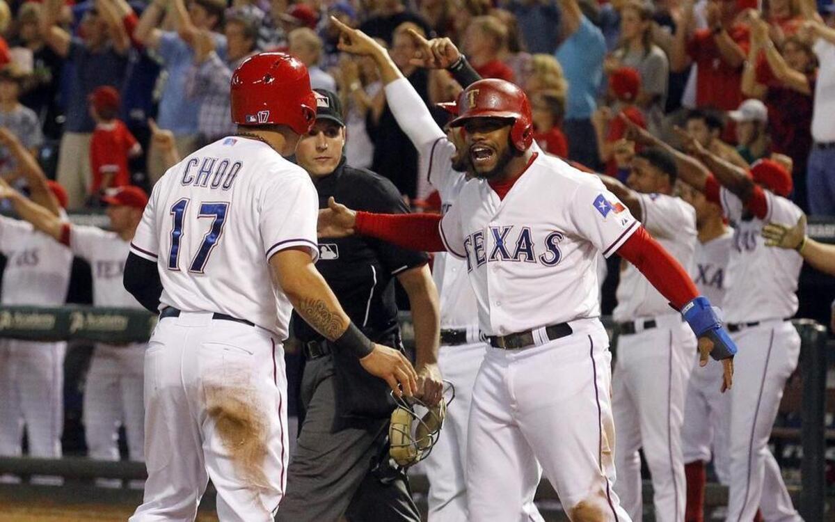 
Rangers Shin-Soo Choo, left, and Delino DeShields celebrate after scoring on a three-run double by Adrian Beltre in the fifth inning Thursday against the Los Angeles Angels at Globe Life Park. Texas won 5-3.
