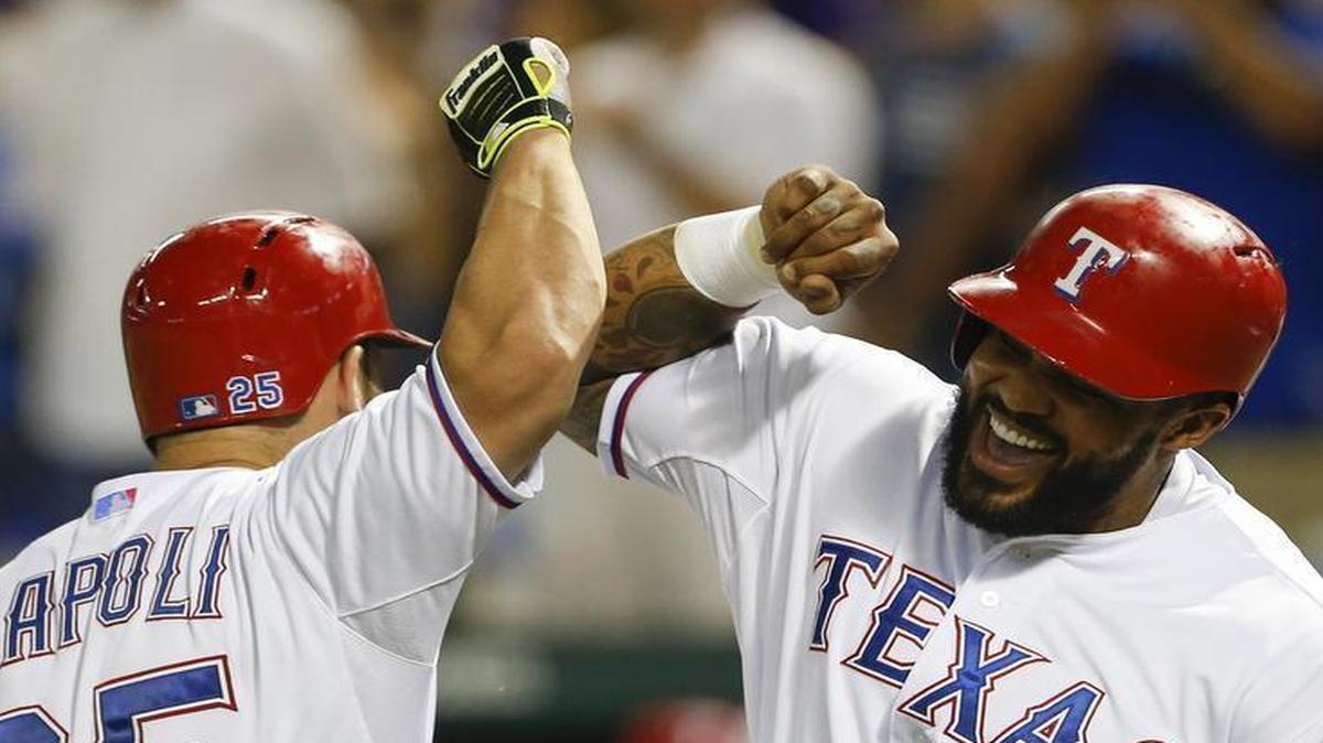 
Prince Fielder gives Mike Napoli a forearm bash after scoring on Napoli’s two-run homer to deep left field.
