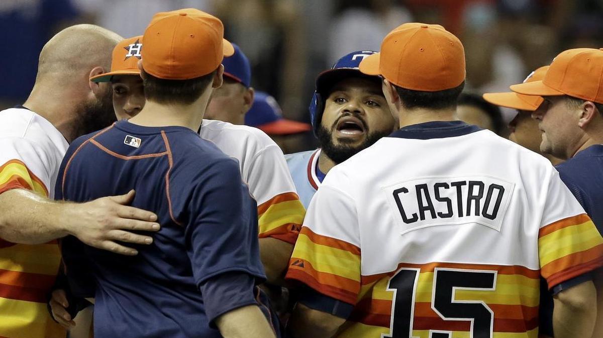
Rangers’ designated hitter Prince Fielder, center, confronts the Astros’ Jed Lowry, in navy blue, after both benches cleared in the ninth inning Saturday at Minute Maid Park. Texas won 7-6.
