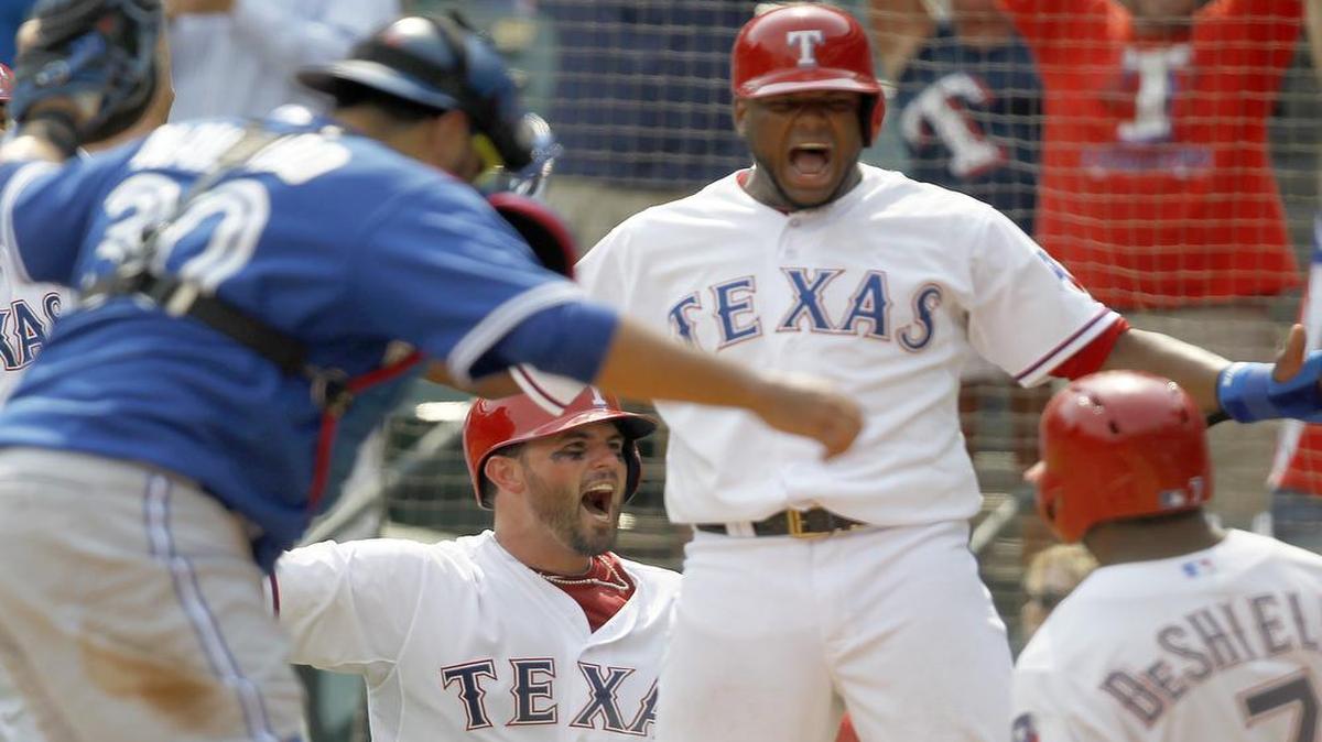 
Rangers catcher Bobby Wilson, left, and Hanser Alberto celebrate with Delino DeShields after they all scored on an error by Blue Jays’ right-fielder Jose Bautista in the seventh inning on August 27.
