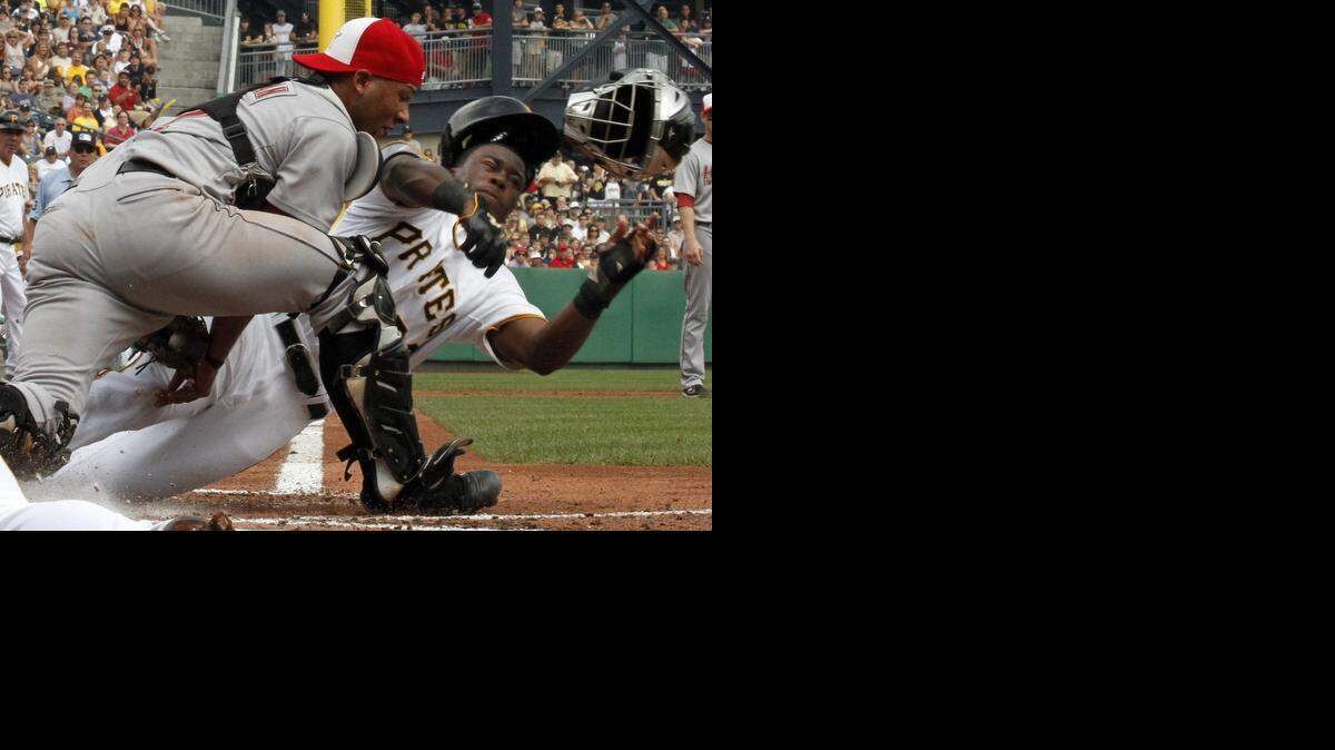 
Former Astros catcher Carlos Corporan, who was traded to the Rangers on Wednesday, tags out the Pirates’ Josh Harrison on a play at the plate in 2011.
