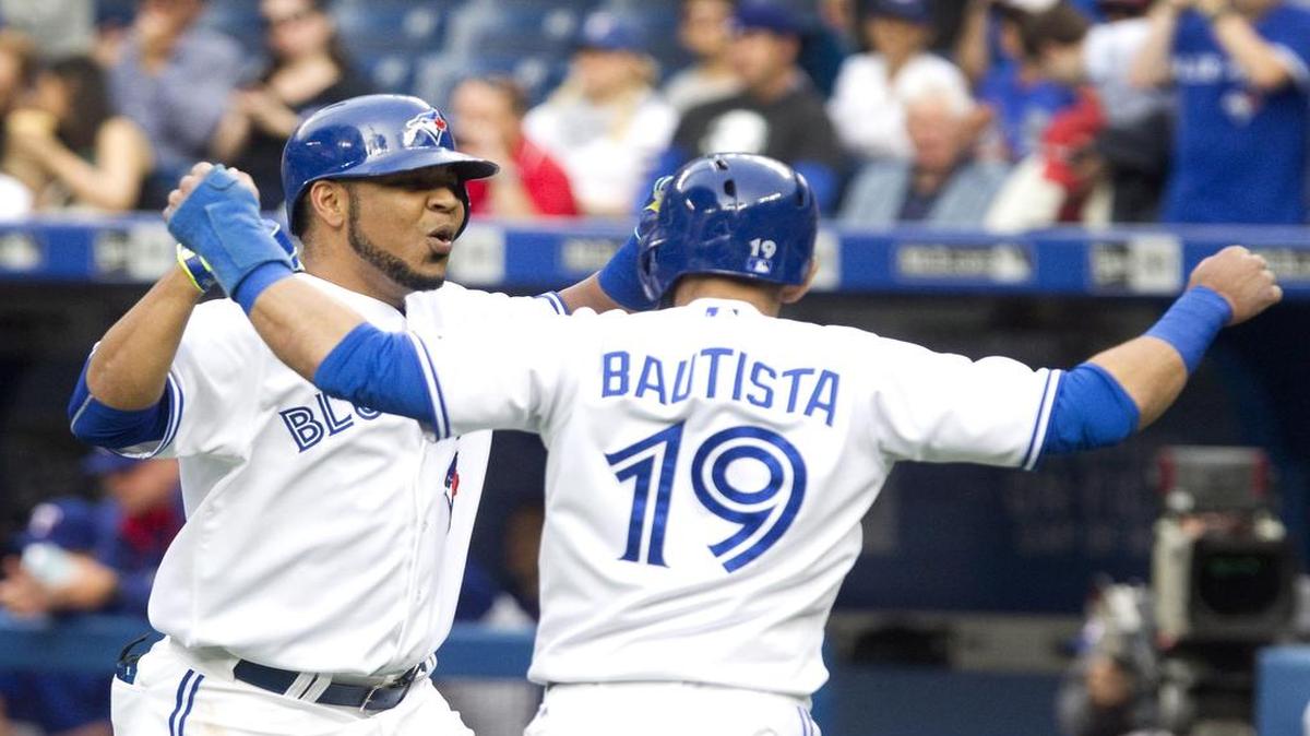 
The Blue Jays’ Edwin Encarnacion is greeted by teammate Jose Bautista at home after hitting a grand slam in the first inning. The Blue Jays beat the Rangers 12-2 Friday at Rogers Centre in Toronto.
