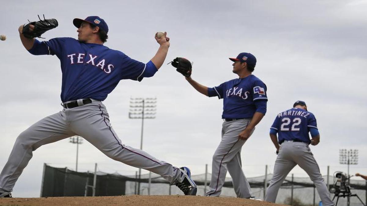 Derek Holland, Cesar Ramos and Nick Martinez throw bullpen sessions Friday during the first workout for Rangers pitchers and catchers.