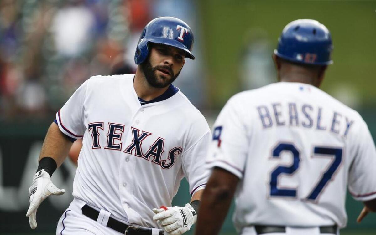 
Rangers’ first baseman Mitch Moreland, left, is congratulated by third base coach Tony Beasley after his three-run homer against the Twins in the fourth inning Saturday at Globe Life Park.
