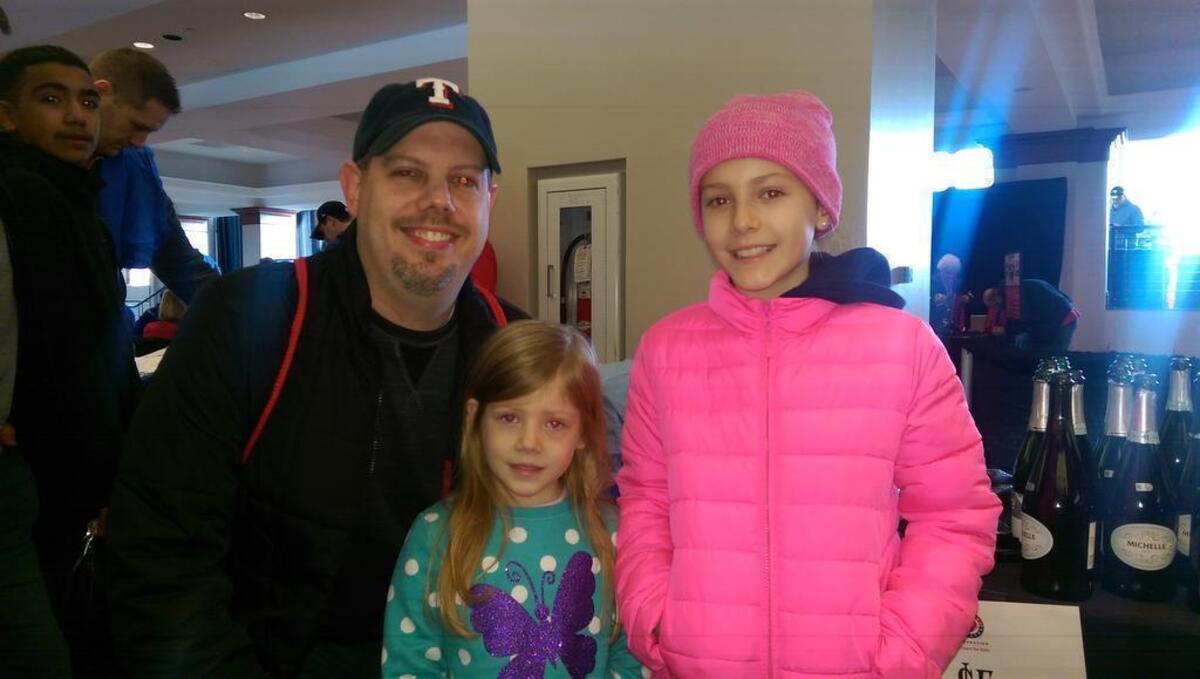 David Wheeler and daughters Ellie and Lauren, right, from Flower Mound, enjoyed their first Rangers FanFest despite the cold temperatures at Globe Life Park Saturday morning.