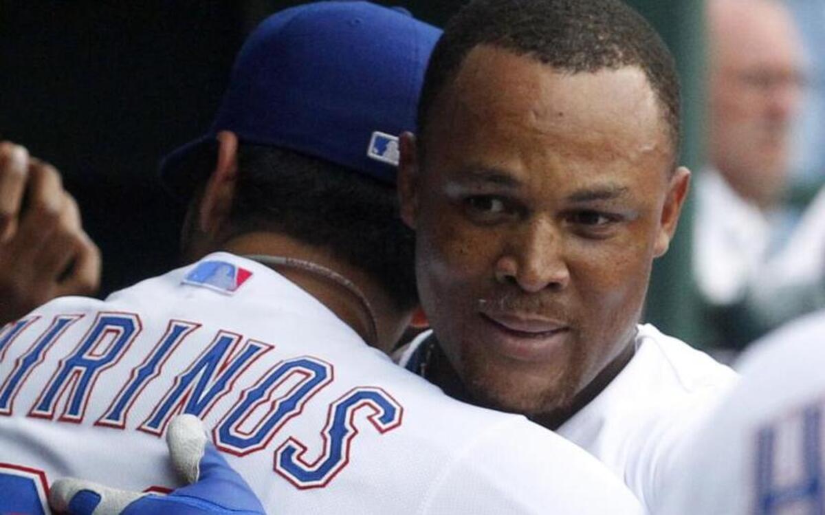 
Texas Rangers Robinson Chirinos (61) hugs Adrian Beltre (29) in the dugout after Beltre hit his 400th home run in a baseball game against the Cleveland Indians at Globe Life Park in Arlington, Friday May 15, 2015. 
