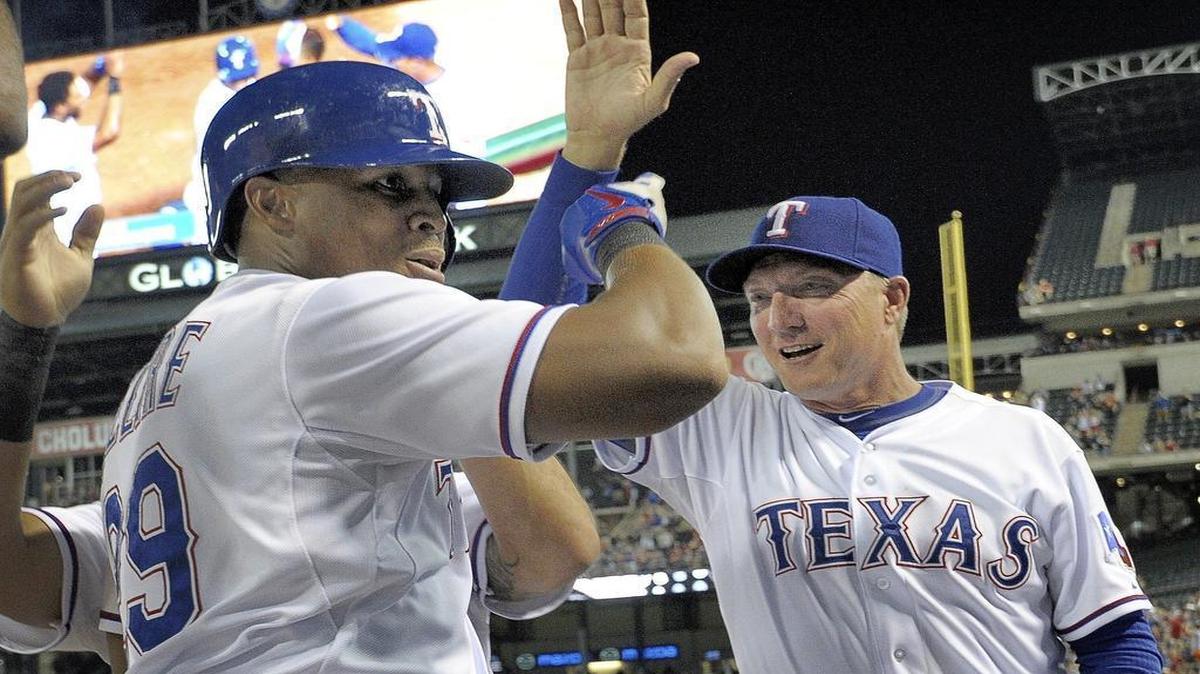 
Rangers manager Jeff Banister, right, congratulates third baseman Adrian Beltre after his fifth inning home run which gave him his third-career cycle. Texas beat the Houston Astros 12-9 Monday night at Globe Life Park.

