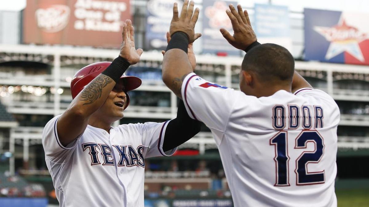 
Rangers’ Shin-Soo Choo, left, is congratulated by Rougned Odor after scoring a run on a double by Adrian Beltre against Mariners in the third inning Monday. Texas won 4-3 in the ninth.
