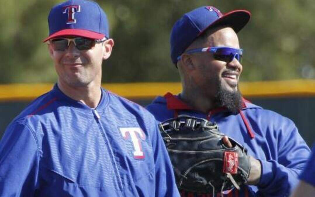 
Former Rangers third baseman Michael Young, now a special assistant, talks with Prince Fielder and the infielders during Thursday’s spring training workout.
