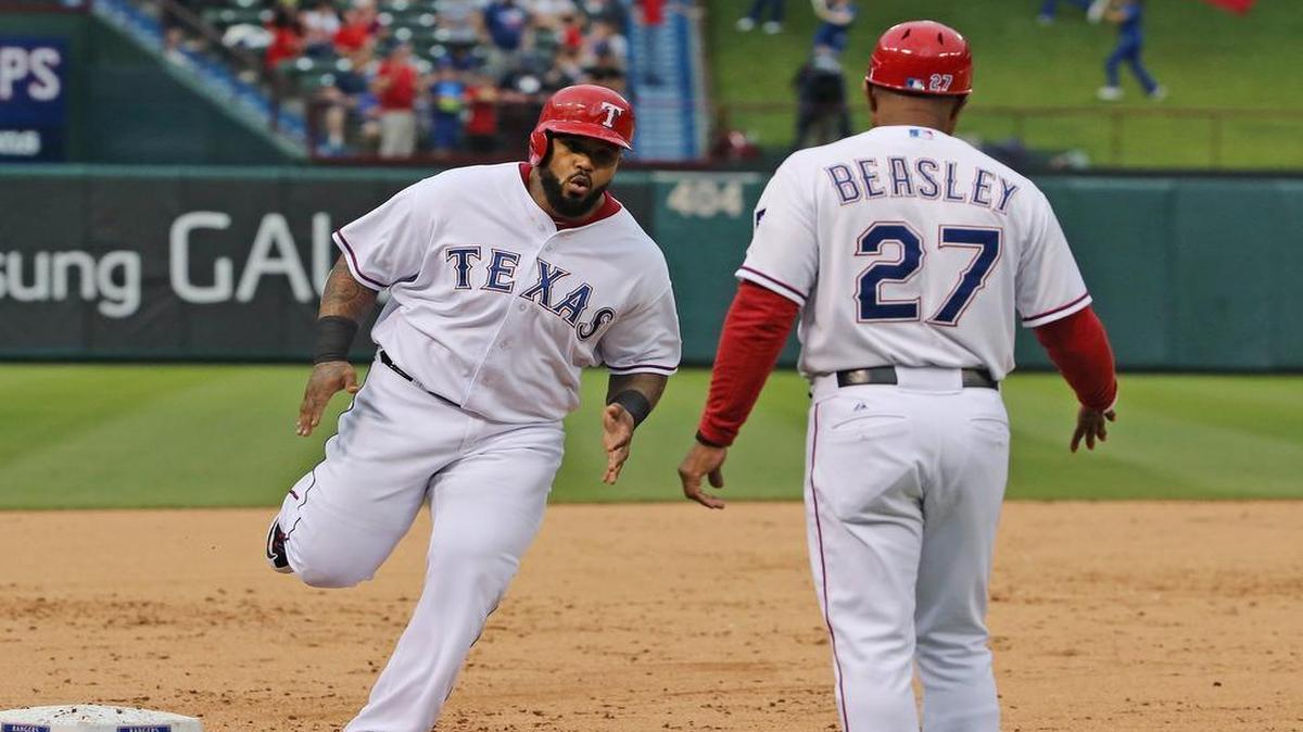 
Rangers designated hitter Prince Fielder approaches third base coach Tony Beasley  after one of his 10 homers this season. Fielder was not in the starting lineup Wednesday for the first time this season.
