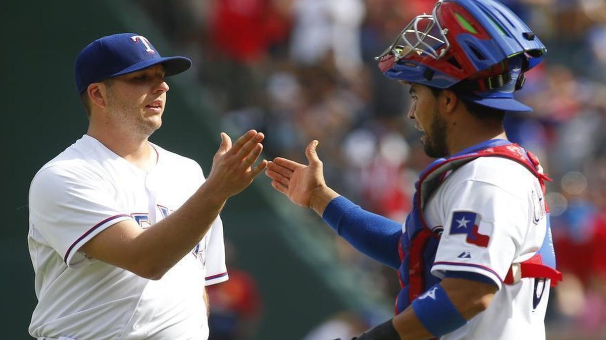 
Right-hander Shawn Tolleson and catcher Robinson Chirinos shake hands Sunday after Tolleson pitched the ninth inning of a 5-1 win over Cleveland.

