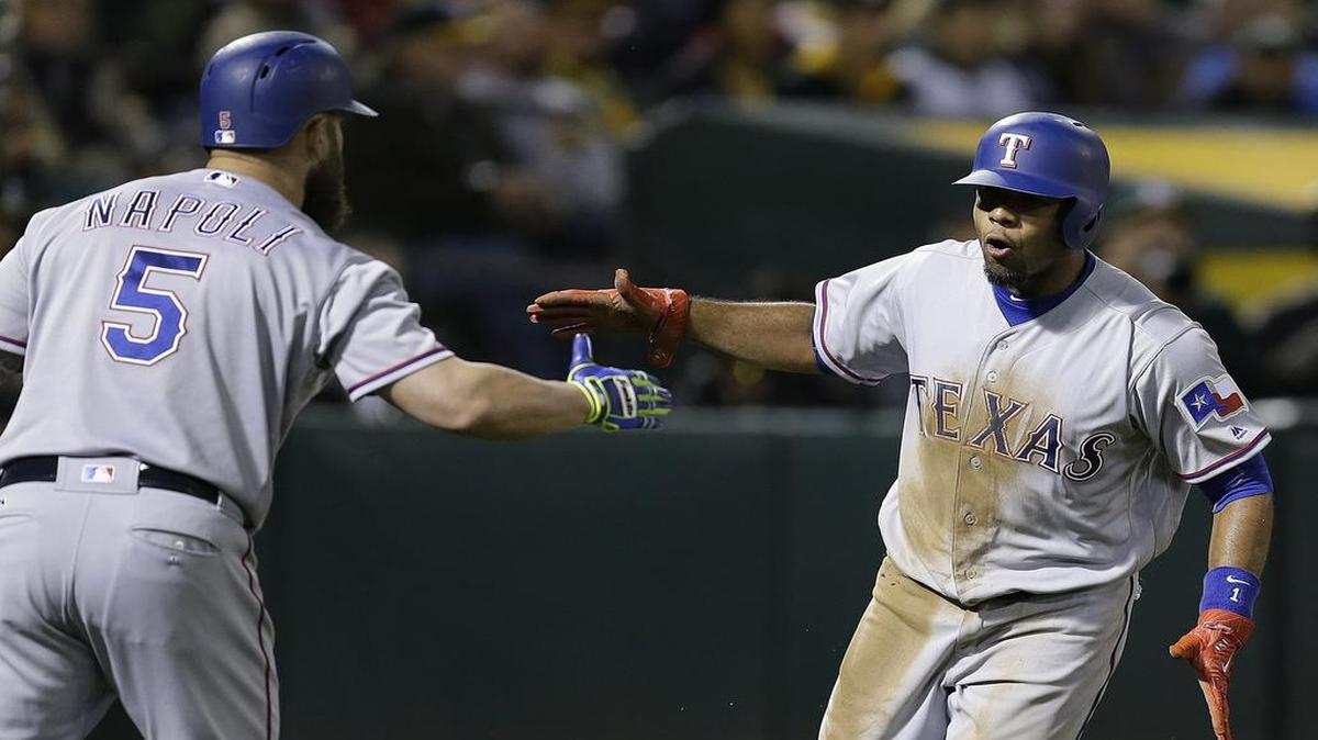 Elvis Andrus, right, celebrates with Mike Napoli after scoring on a close play at home. Andrus drove in a run earlier in the inning and stole two bases to give the Rangers’ a 2-0 lead in the sixth Tuesday night.