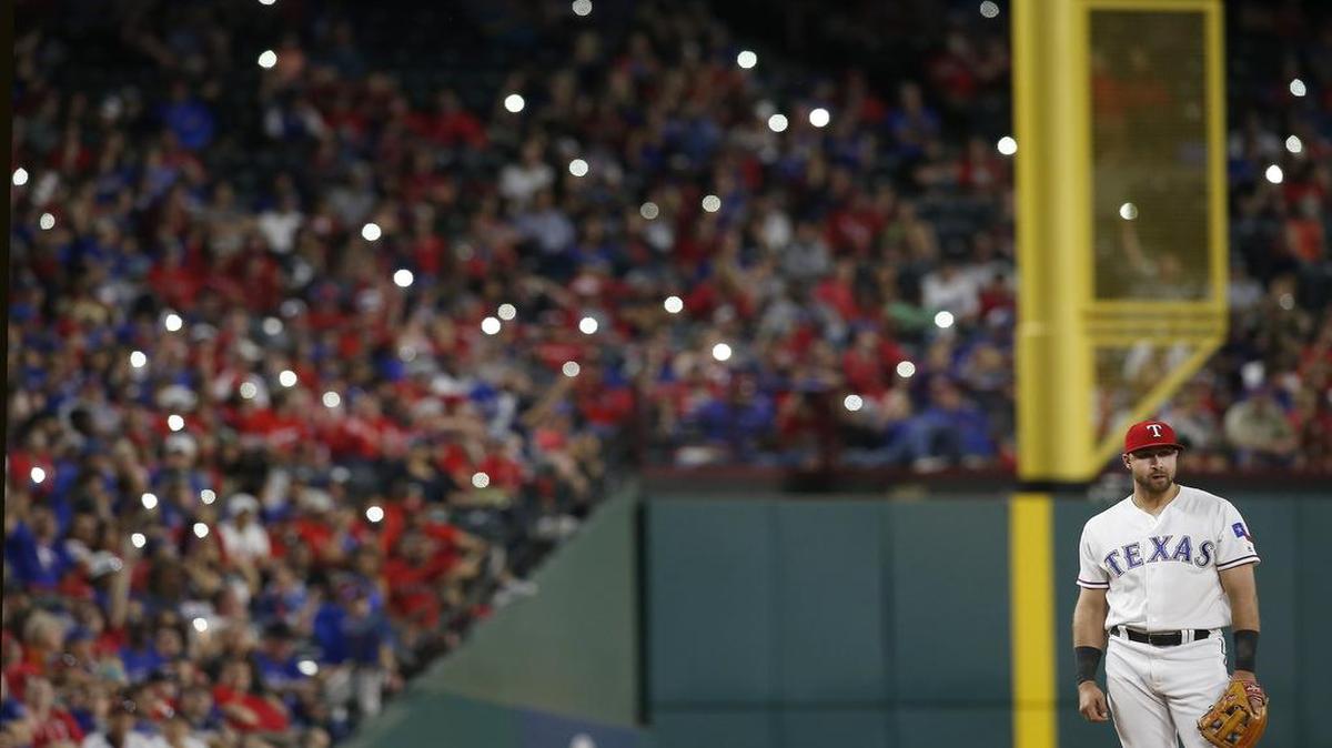 Rangers fans light their phones during a game at Globe Life Park in April with third baseman Joey Gallo looking on between pitches. The Rangers announced upper reserved seats are $5 for Sunday’s game against the Angels.