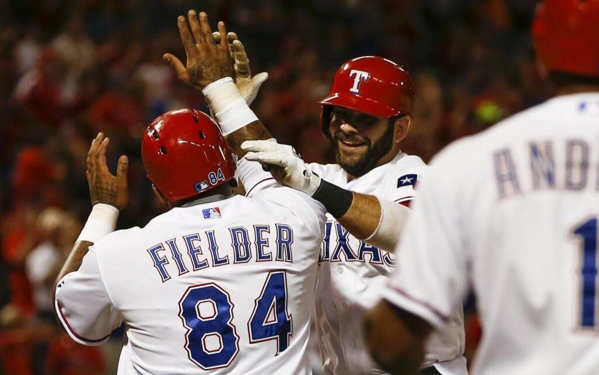 
Rangers’ Mitch Moreland, middle, celebrates his sixth-inning home run with Prince Fielder against the Astros Monday night at Globe Life Park. Texas beat Houston 5-3 to pull within a half game of the Astros in the American League West.
