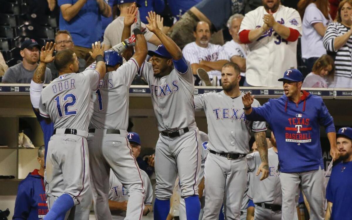 
Rangers players celebrate with Elvis Andrus, second from left, after he scored on Mitch Moreland’s go-ahead double against the Padres in the tenth inning Wednesday at Petco Park. Texas won 4-3 to improve to a season-high eight games above .500.
