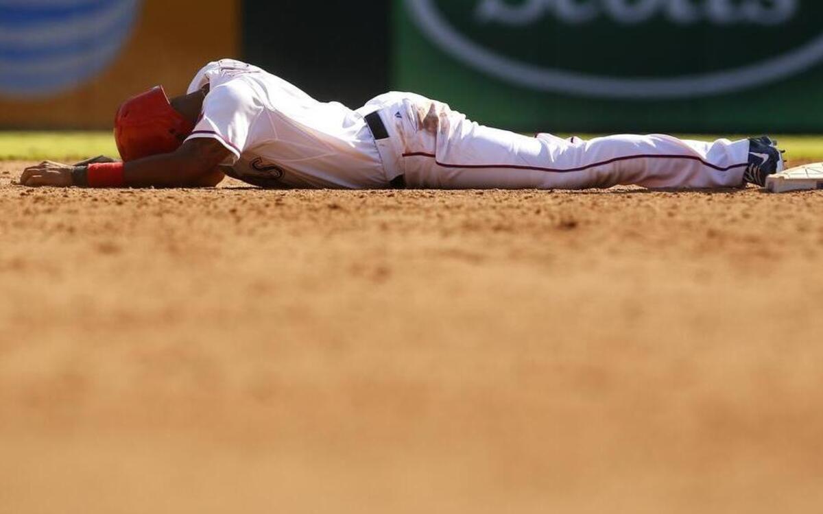 
Texas Rangers Elvis Andrus (1) lies on the ground after being tagged out trying to steal second to end the game as the Angels beat the Rangers 11-10 at Globe Life Park in Arlington, TX Saturday.

