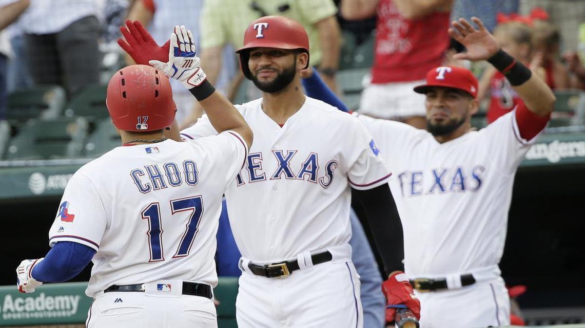 Shin-Soo Choo, left, is met at the dugout by Nomar Mazara, center, and Robinson Chirinos, right, after he homered on the first pitch in the bottom of the first for the second time in the past four games Tuesday night. The Rangers beat the Rays 9-5 at Globe Life Park.